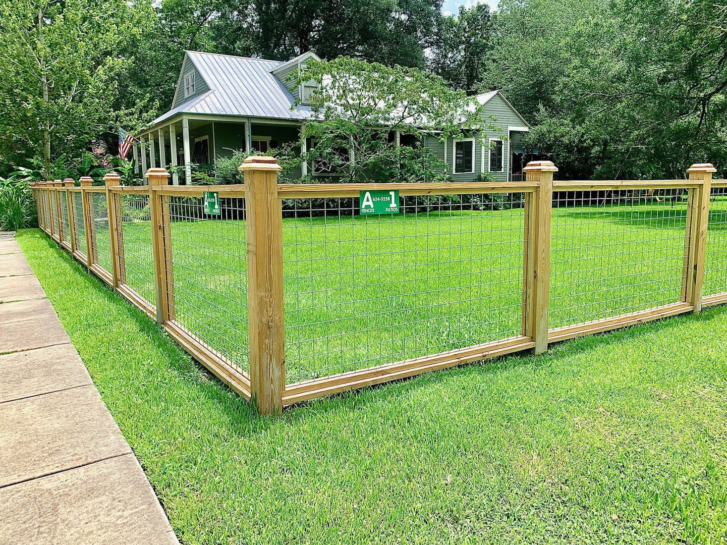 Custom wood fence with hog wire panels